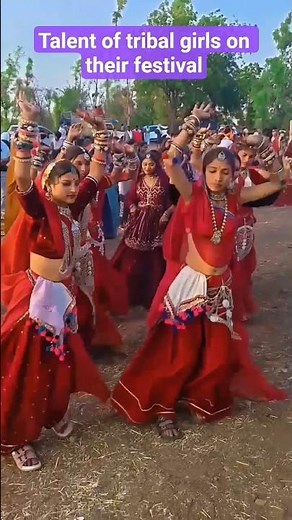 tribal girls with their traditional attire enthiastically dancing in theirl annual festival