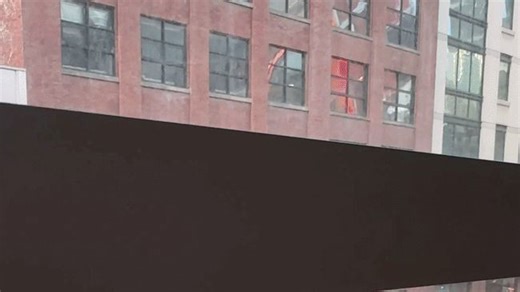 Stunned gymgoers watch on as fireball explodes at building across road