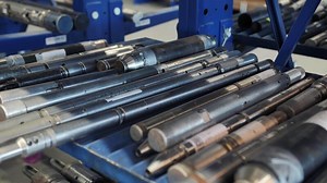Oil drilling tools organized on metal racks in warehouse