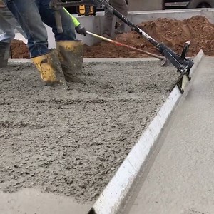 Using a vibrating screed to level and smooth the concrete Done by Fox Cities Builders! ⚒ | ARCFLY