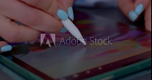 Close-up hands teacher and student in process learning how create animation using tablet and stylus. Touching screen with digital pen. 12.04.2022 V Holesovickach, Prague, Czech Republic