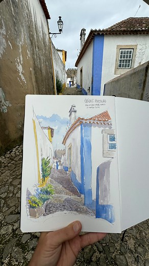 Best timing to see an urban sketch! @hahnemuehle_global A4 sketchbook @winsorandnewton watercolours #pov #urbansketch #obidos #portugal #art #sketchbook #watercolor #inkpensketch | World Sketching Tour