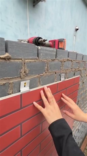 Someone installs red brick wall panels using a drill and screws #construction #popular