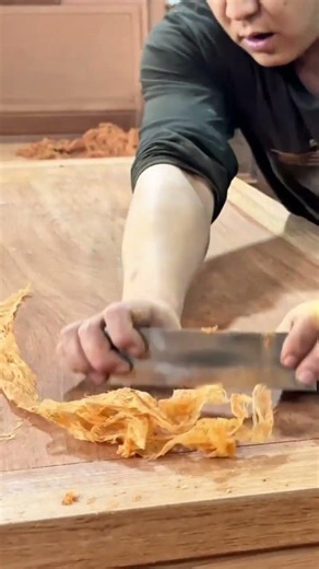 Smoothing wooden furniture surfaces using hand scrapers to create perfectly flat and elegant texture