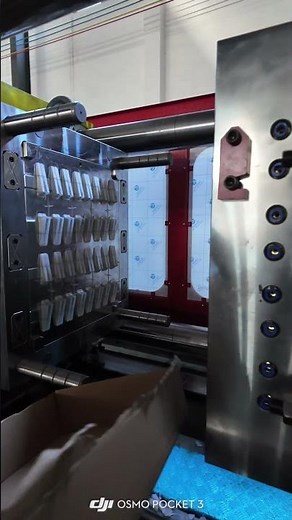 Plastic injection molding machine is producing 32 cavities tile leveling tool. #injection #machine