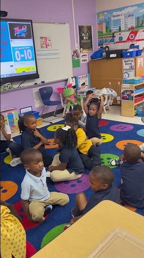 PreK4 Teacher, Mrs. Harley using the turn and talk method with her four year old students.