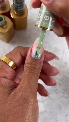 Green gradient aura nails giving overcast days with much welcomed fog 🌪️🌳🫧 The quick glimpse of these shades in matte was 👌🏽😮‍💨 Shop the last few days of our $5 Gel Polish Sale by clicking the link in our bio. @sadiejnails wearing greens from the DIVA Happy Trails Collection: DIVA 277 Foggy Fern DIVA 241 Wild Sage DC 200 Matte Top Coat DIVA 300 Top Gel No Cleanse Would you wear this look? #dndgelpolish #greenails #dndgel #nailsoftheday #nailsofinstagram #prettynails #auranails #fallnails 
