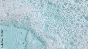 Soap Foam Moving in Blue Background. Natural White Shampoo Bubbles Motion. Bathtup Soap Foam. Texture of Soap Foam Bubbles. High quality 4k footage