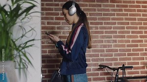 beautiful young asian woman getting ready leaving apartment using smartphone texting late for work