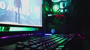 Modern Gaming PC On Desk with RGB Lights Glowing in Gamer's Dark Room