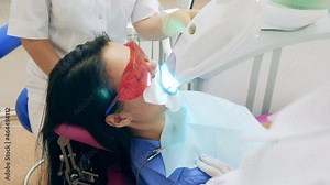 Oral hygiene procedure is being carried out on a female patient