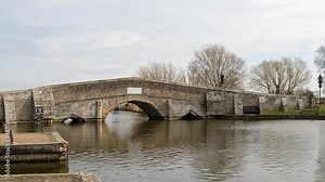 Historical stone bridge over the River Thurne in the small village of Potter Heigham in the heart of the Norfolk Broads