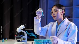 Scientists use scientific test tubes with records of chemicals or drugs being tested and examined under a microscope in a science laboratory for biology, biotechnology, medicine.