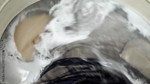 Washing machine top loading. Laundry of bed linen and clothes.