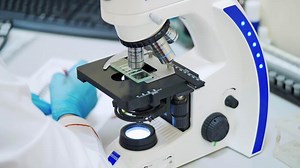Female doctor with microscope. Lab technician with microscope in hospital laboratory