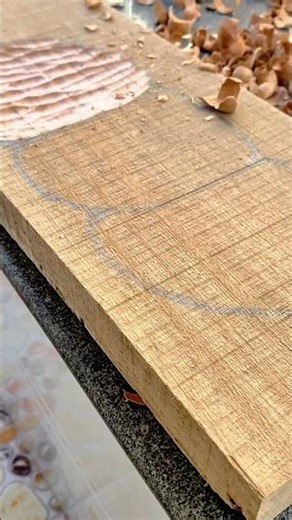 Shaping wood surface using a handheld power router for detail work