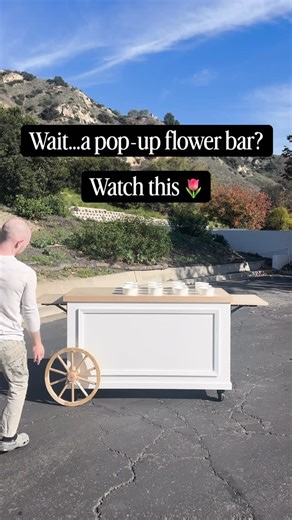 Sam & Gina Ridgley on Instagram: "Designed to bloom anywhere. 🌸 This collapsible flower bar packs flat, sets up fast, and rolls wherever your pop-up takes you: markets, weddings, events, and beyond. Thoughtfully built for florists on the move, with customizable counters, smart storage, and an easy solo setup that keeps things simple and beautiful. Ready to pop up? Let’s make one just for you. Comment INTERESTED for our pricing sheet and order form. #FlowerCart #FlowerBar #PopUpFlorals #FloristL
