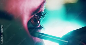 Eye, cosmetics and makeup of creative woman artist applying dramatic bright shadow zoom and closeup. Model girl making a bold, creative and punk style cosmetic beauty look on eyes and lashes