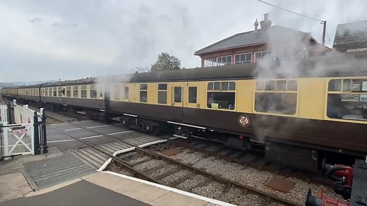 Nunney Castle leads a rake of eight chocolate and cream coaches into Blue Anchor wearing the iconic Cheltenham Spa Express headboard. 9351 waits patiently on the down platform…. | Blue Anchor Station - news and needs.