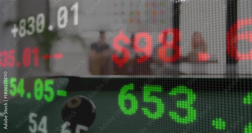 Market ticker scrolling, revealing lounge, team gesturing at tablets and analyzing finance trends