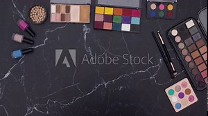 Stop motion animation of make up and cosmetics products appear on the table