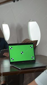Businesspeople with laptops have meeting in corporate jet. Green screen ready for programm track replace laptop monitor. Three entrepreneurs discussing about business. Vertical shot.
