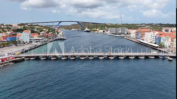 Floating Bridge At Punda In Willemstad Curacao. Caribbean Island. Downtown Skyline. Punda At Willemstad Curacao. Famous Bridge Landmark. Colored Buildings.