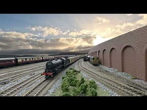 Model railway, authentic squeaky clanking rolling stock, decent length trains, moving cloudy skies