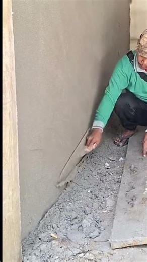 a cement mixture being leveled using a special tool by a worker