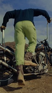 - cable knit wool sweater, sweat pants… the Beach, the Machine, the Beginning Boots sinking. Heavy. Wet sand. The wind tearing sideways — screaming. Ocean. Surfers — black needles against a bleeding sky. God, the colors. Blue. Grey. Slashing open the dark. Wool sweater heavy with salt. Terry sweatpants dragging at the knees. The sand and the wind. The machine. ‘48 Panhead sleeping half-awake. Slick with mist. Clutch gleaming like a broken tooth. Engine coughing, snarling, alive. Coast shaking. T