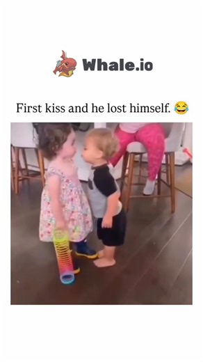 Unviversal Clips on Instagram: "This Instagram reel shares a 8-second clip of two toddlers attempting a clumsy first kiss in a kitchen, with the boy's dazed, wide-eyed reaction providing the comic highlight that embodies innocent awkwardness. , whose profile focuses on feel-good viral videos and reminders to approach online content lightly, the clip has attracted 455 likes and diverse replies blending humour with nostalgia for childhood purity. The video's charm lies in its unscripted authentici