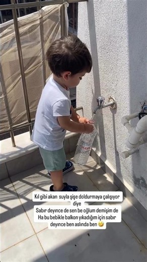 🎯 The baby filling a bottle with water with patience 🥰