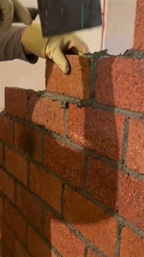 installing bricks inside the house to make new wall, stick it and tap it to hold it in #construction