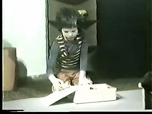 Pinwheel - Kid plays with blocks that begin moving (stop motion live action)