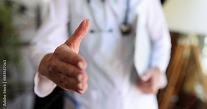 Female doctor holds out hand for handshake or greeting. Getting to know doctor insurance and providing medical care