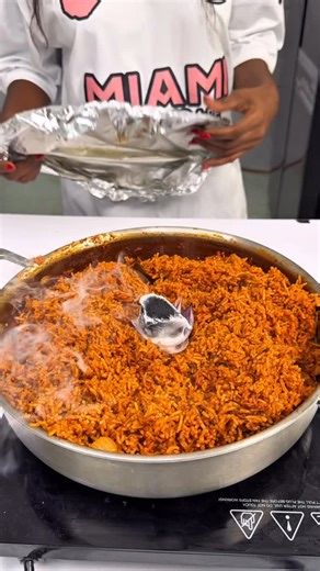 Shirley Atieno on Instagram: "Smokey Jollof Rice Served with Suckling Pig. What to do: Jollof Rice Soak your long grained rice for 30min - I used @worldofsunrice Then Roast/Bake Redbellp,Onions,Tomato,Salt,Oil,Thyme,Garlicbulb&Hot pepper for 30min at 180 degrees Then blend the roast to thickness not runny On a pan saute whiteonions,tomatopaste,jollof base, currypowder,thyme,bayleaf. Then add your soaked rice. Cook for 30min low heat then ass a burning coal on oil trapped in onion leaf. Suckling 