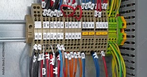 Terminal blocks in electrical cabinet. Cable connector. Industrial electrical equipment and wiring. Terminal blocks for electrical connection, electrical panel at a assembly with number tag equipment