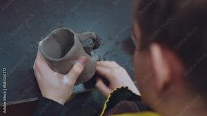 The process of working with clay, a clay master class, making a mug out of clay