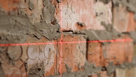 clip-4022830259-female-construction-worker-using-laser-level-making