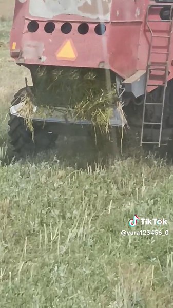Combine Harvester Efficiently Harvesting Hay in Field