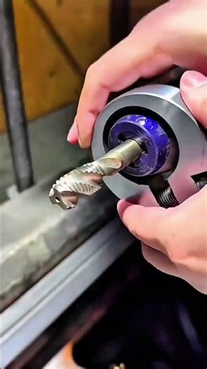Helical cutter spins sharp flutes bite metal