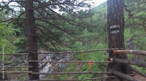 Traveler explores a mountain river. It moves up the river. He has in his hands an action camera with a stabilizer.