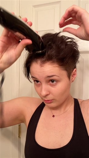 Girl Shaving Her Head Bald With Clippers In Her Room