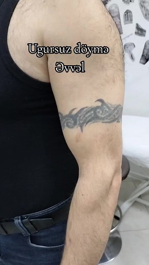 Stunning Tribal Tattoo on Male Arm in Tattoo Studio