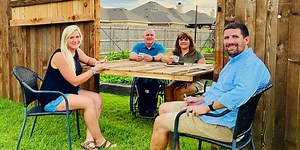 In a time of distancing, local residents turn fence into a bridge