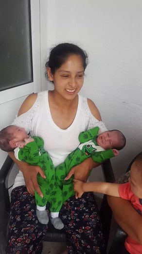 Caring Moments: Woman with Infants in Matching Onesies
