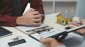 Download Real estate agent and customer signing contract to buy house, insurance or loan real estate.rent a house,get insurance or loan real estate or property. for free