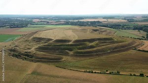 Maiden Castle, Dorset UK. Aerial video E. over W. entrance prehistoric Iron Age hillfort ramparts and ditches dates from 4000 BC causewayed enclosure