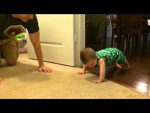 Baby doing push-ups with daddy