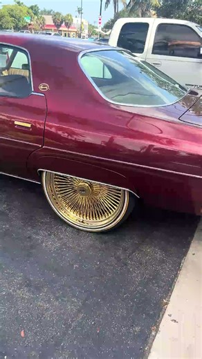 4-door Chevy donk on gold 24’s Daytons riding out